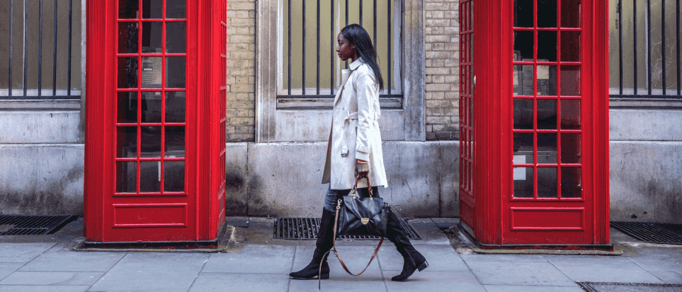 A professional woman walking down a street in London.