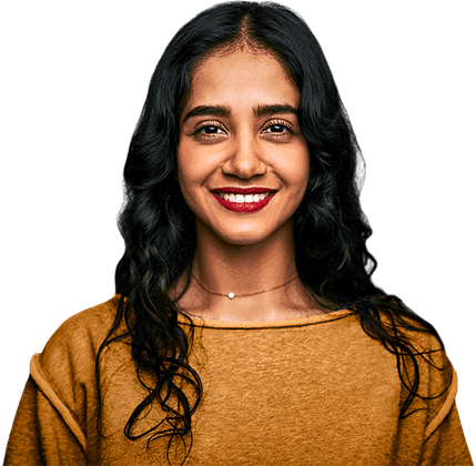 Young Indian woman with long black hair wearing tan sweater smiling
