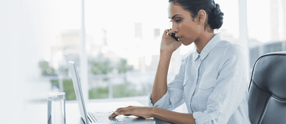 Woman on the phone and working on her laptop