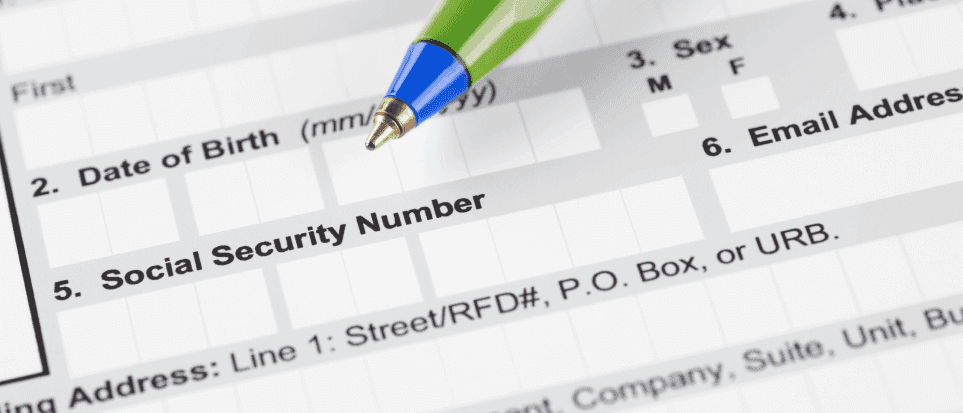 Job application form with a pen next to the Social Security number field.