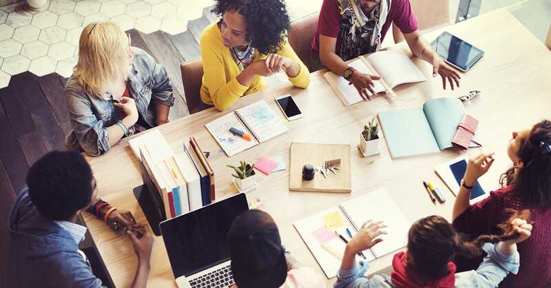 Group of diverse people sitting at a table having a business meeting